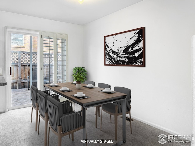 dining room featuring baseboards and carpet