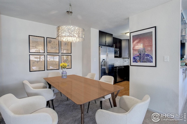 dining space with a notable chandelier and baseboards