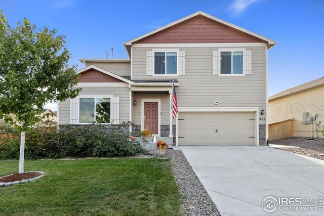 999 Cascade Falls St, Severance, CO 80550 - view of front of house with a front yard, stone siding, a garage, and driveway