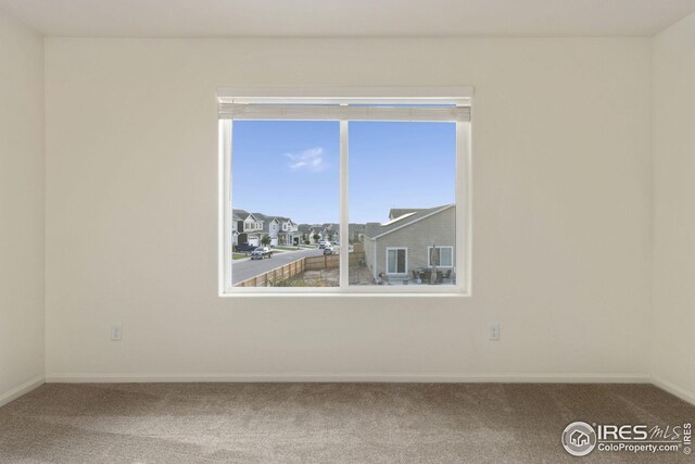 999 Cascade Falls St, Severance, CO 80550 - carpeted empty room with baseboards and a residential view