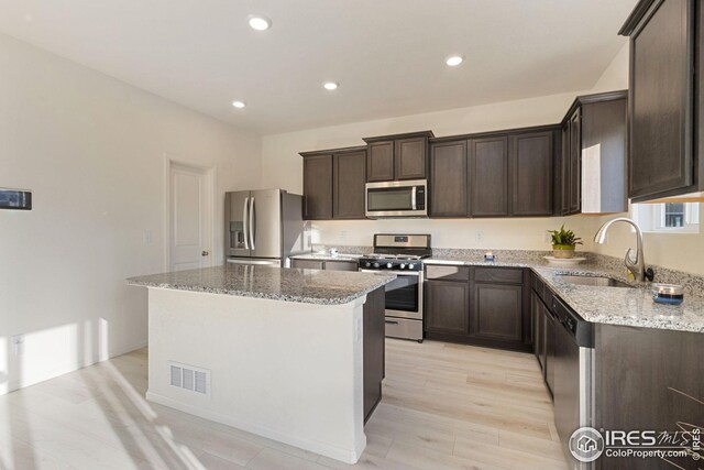 999 Cascade Falls St, Severance, CO 80550 - kitchen featuring a sink, visible vents, appliances with stainless steel finishes, and dark brown cabinets