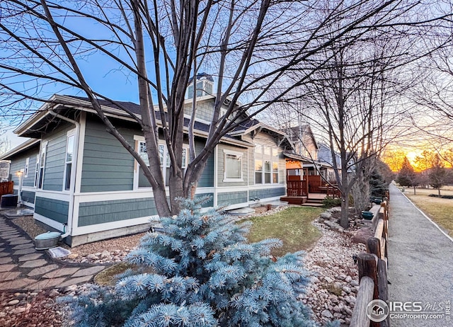 view of property exterior with a wooden deck