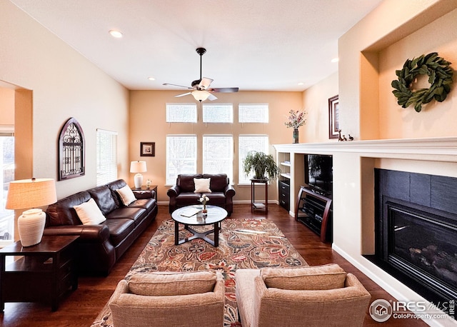 living room with wood finished floors, baseboards, a fireplace, recessed lighting, and ceiling fan