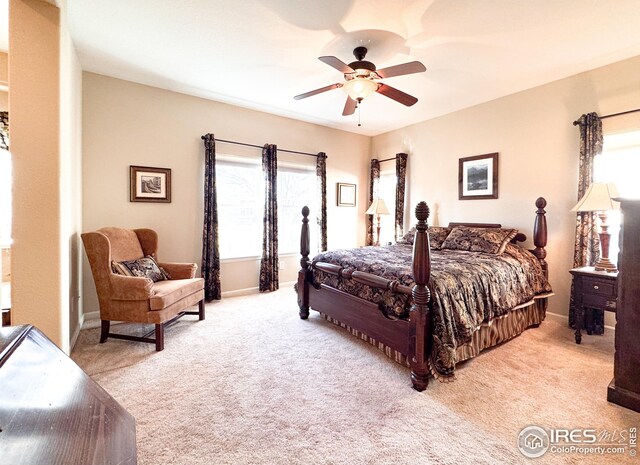 carpeted bedroom featuring baseboards and a ceiling fan