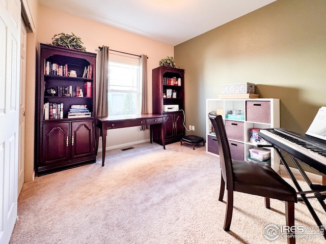 carpeted home office featuring visible vents