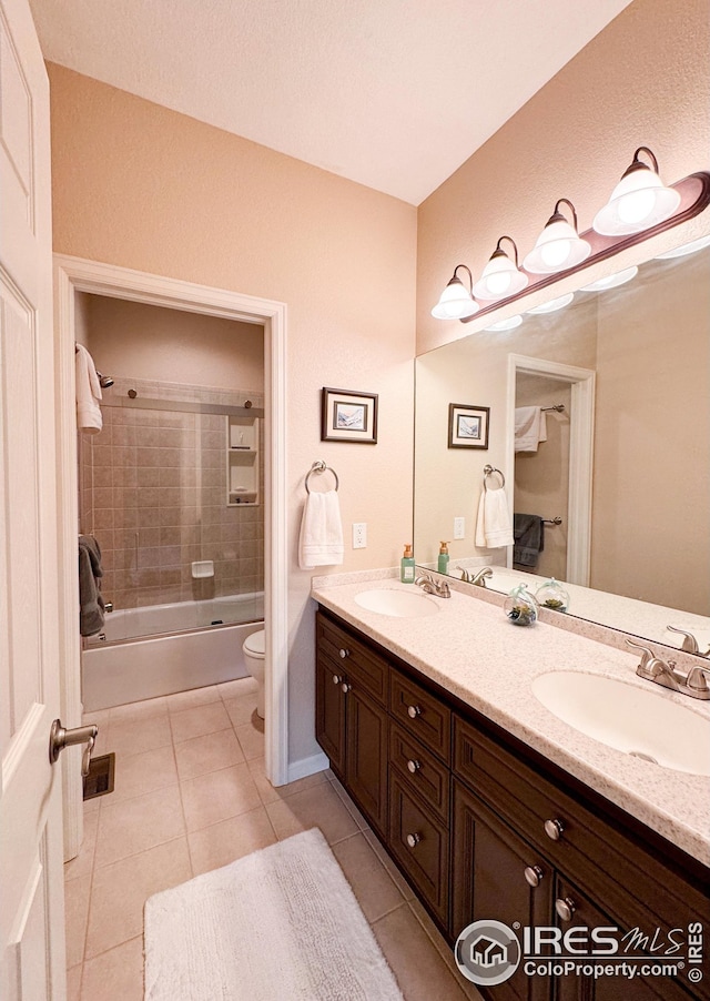 full bathroom with tile patterned flooring, double vanity, toilet, and a sink