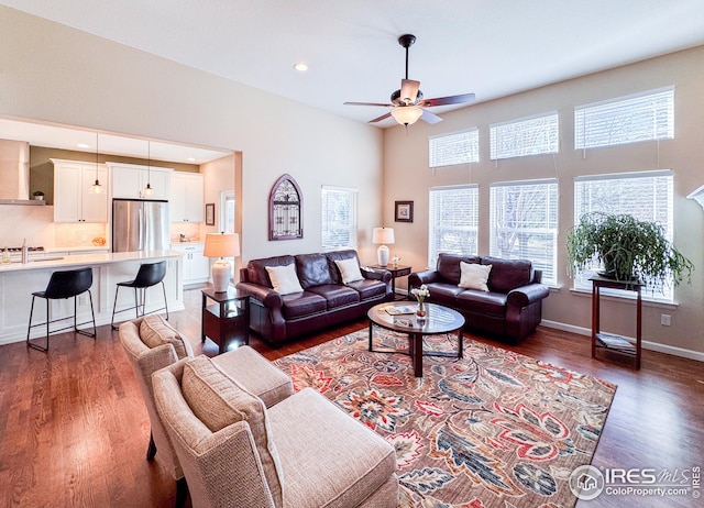 living area with recessed lighting, baseboards, wood finished floors, and ceiling fan