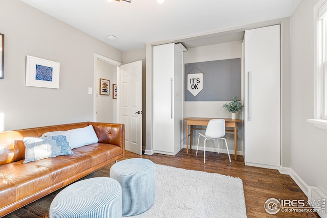 living area featuring baseboards and wood finished floors