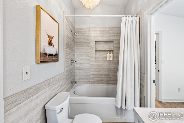 bathroom featuring vanity, toilet, and shower / tub combo with curtain