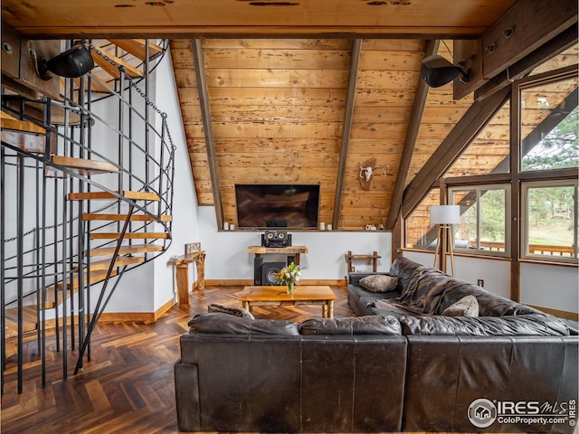 living room with lofted ceiling with beams, stairs, and baseboards