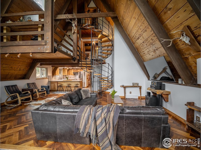 living room featuring lofted ceiling with beams, stairway, wood ceiling, and baseboards