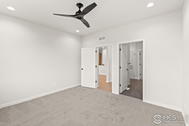 unfurnished bedroom with visible vents, recessed lighting, connected bathroom, carpet flooring, and baseboards