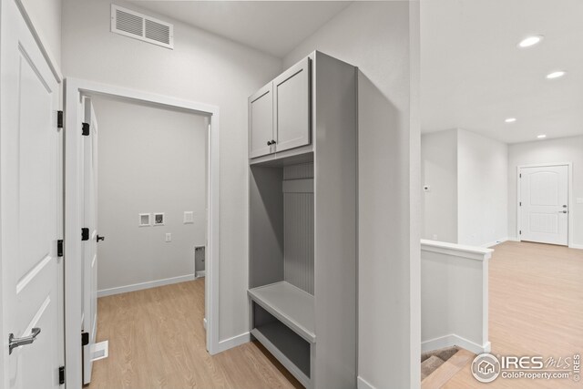 mudroom with recessed lighting, light wood-style floors, visible vents, and baseboards