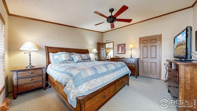 bedroom featuring ceiling fan, visible vents, crown molding, and light carpet