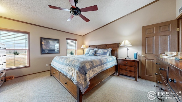 bedroom with vaulted ceiling, a ceiling fan, light carpet, crown molding, and a textured ceiling