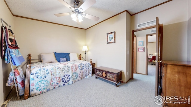 bedroom with visible vents, carpet, a textured ceiling, and ornamental molding