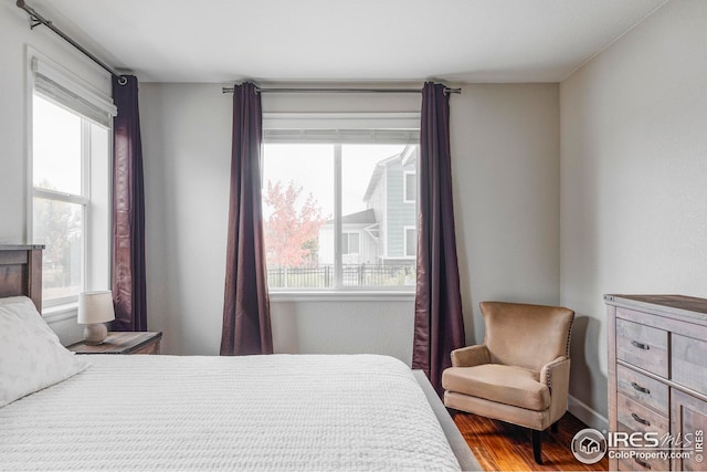 bedroom featuring multiple windows and wood finished floors