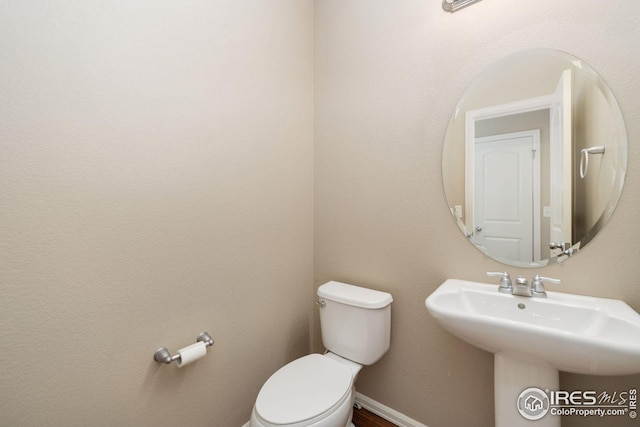 half bath with a sink and toilet
