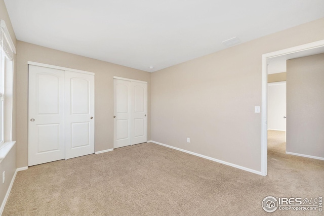 unfurnished bedroom featuring baseboards and carpet flooring