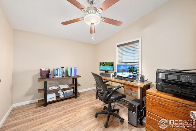 home office featuring vaulted ceiling, a ceiling fan, light wood-type flooring, and baseboards