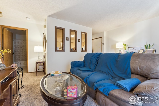 carpeted living room featuring a textured ceiling and baseboards