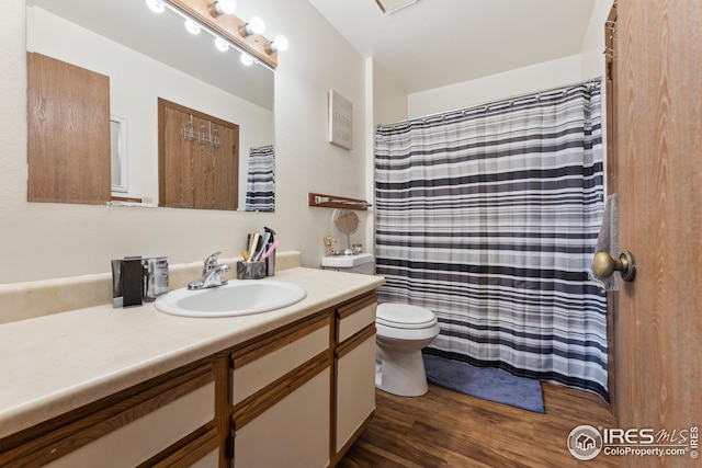 bathroom featuring vanity, toilet, and wood finished floors