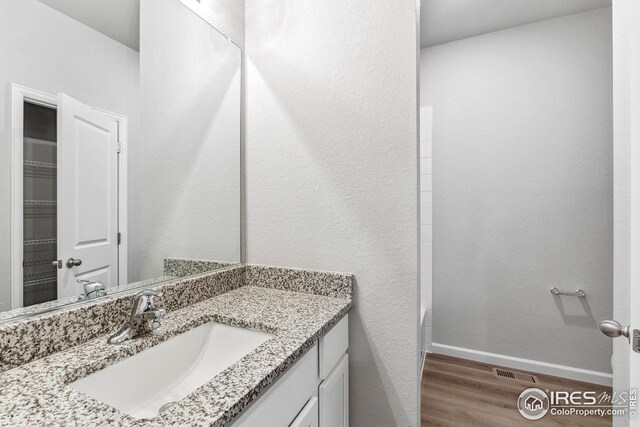 952 Cascade Falls St, Severance, CO 80550 - full bathroom featuring wood finished floors and vanity