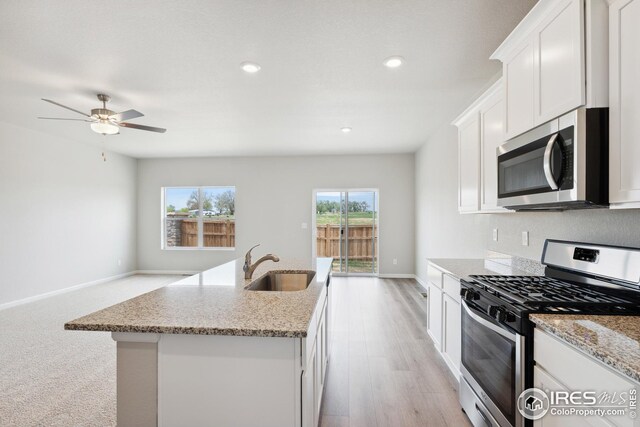 952 Cascade Falls St, Severance, CO 80550 - kitchen featuring stainless steel appliances, a ceiling fan, light stone counters, recessed lighting, and white cabinets