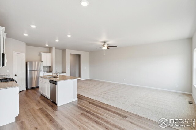 952 Cascade Falls St, Severance, CO 80550 - kitchen with stainless steel appliances, ceiling fan, white cabinetry, an island with sink, and recessed lighting