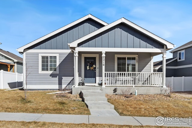 4216 Yellowbells Dr, Evans, CO 80620 - bungalow with covered porch, fence, and board and batten siding