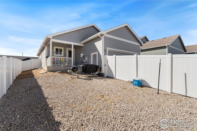 4216 Yellowbells Dr, Evans, CO 80620 - back of house featuring covered porch, an attached garage, and a fenced backyard
