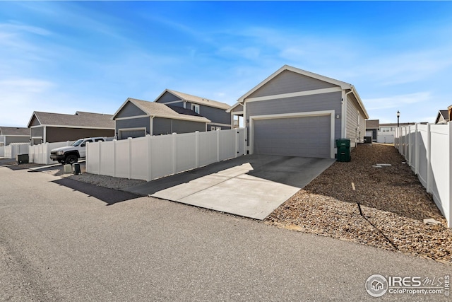4216 Yellowbells Dr, Evans, CO 80620 - view of home's exterior featuring fence, driveway, and an attached garage