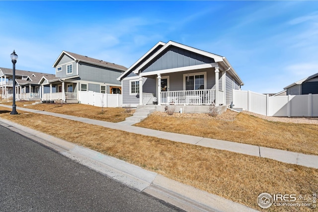 4216 Yellowbells Dr, Evans, CO 80620 - view of front of property with covered porch and board and batten siding
