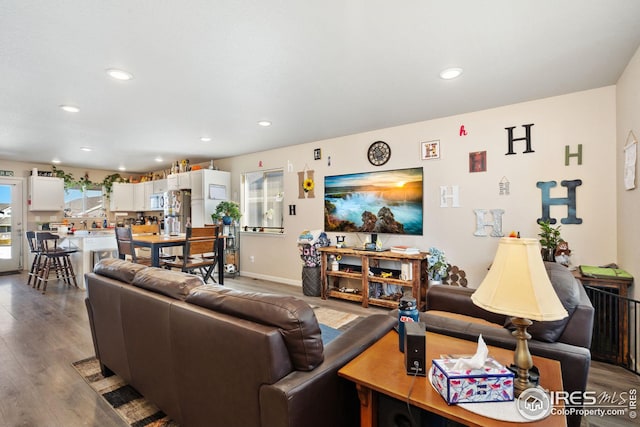 4216 Yellowbells Dr, Evans, CO 80620 - living area featuring wood finished floors and recessed lighting