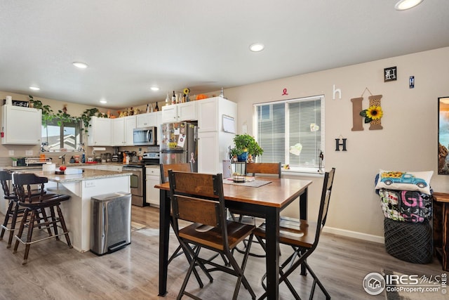 4216 Yellowbells Dr, Evans, CO 80620 - dining space featuring light wood-type flooring, recessed lighting, and baseboards