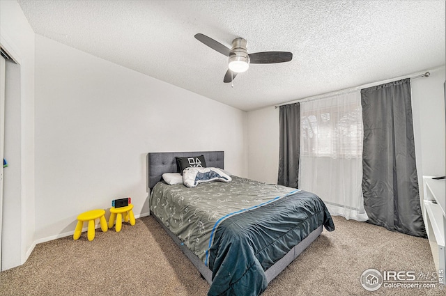 bedroom featuring a ceiling fan, carpet, baseboards, and a textured ceiling