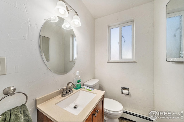 bathroom with vanity, toilet, and baseboard heating