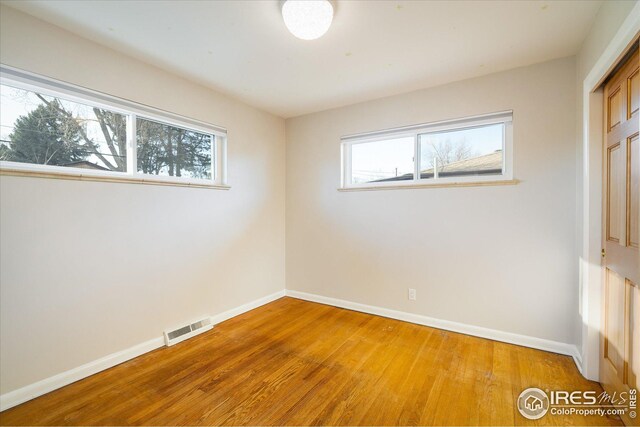 169 Emerald St, Broomfield, CO 80020 - empty room featuring visible vents, baseboards, and hardwood / wood-style flooring
