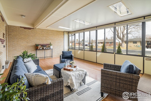 169 Emerald St, Broomfield, CO 80020 - sunroom featuring brick wall, outdoor lounge area, and wood finished floors