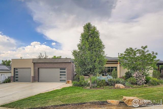 8568 Foxhaven Ct, Niwot, CO 80503 - view of front facade with a front lawn, driveway, stucco siding, and brick siding