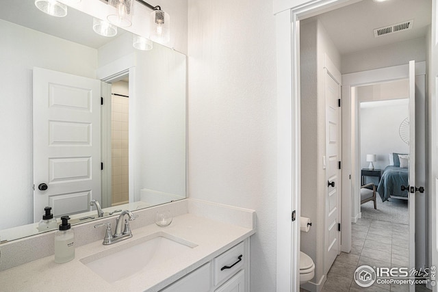 full bathroom with vanity, toilet, visible vents, and tile patterned flooring