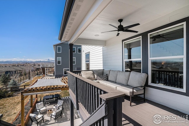 balcony with outdoor lounge area, a grill, a mountain view, and ceiling fan