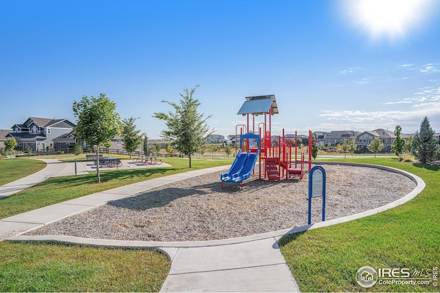 communal playground with a residential view and a lawn