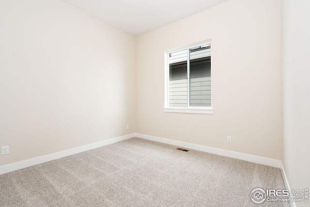 unfurnished room featuring baseboards, visible vents, and carpet floors