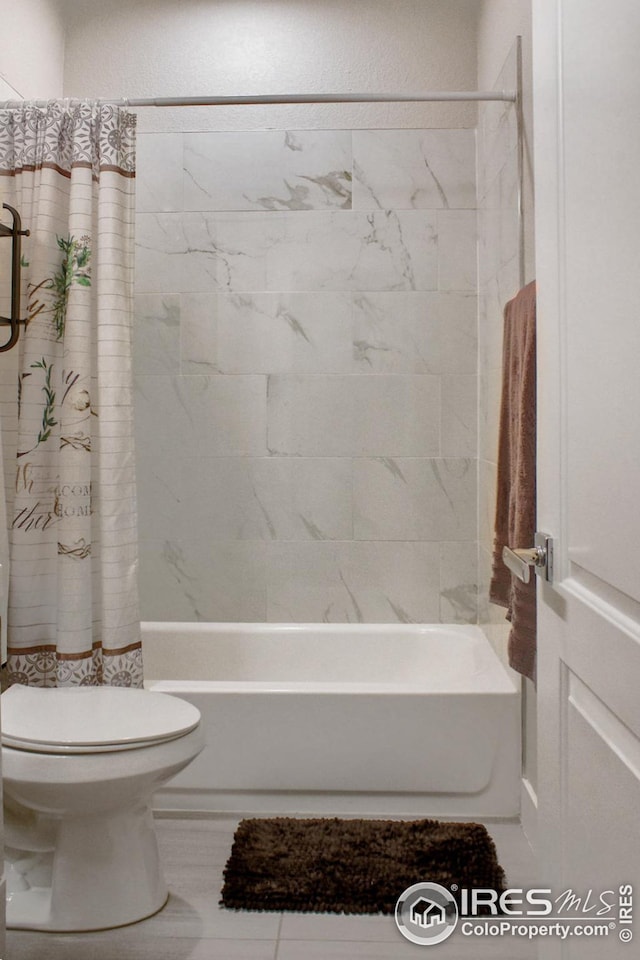 bathroom with toilet and shower / tub combo