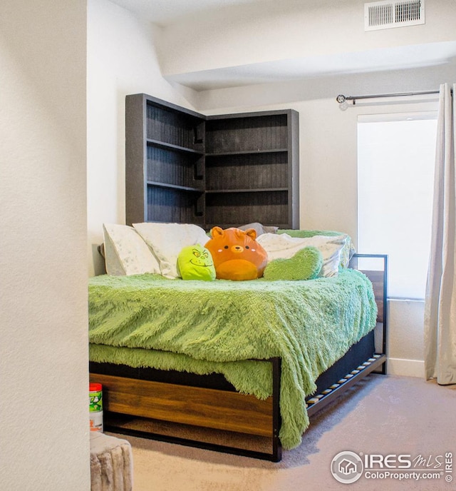 bedroom with visible vents and carpet flooring