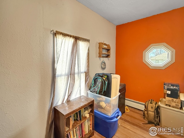 105 N Logan Ave, Haxtun, CO 80731 - sitting room with a baseboard heating unit and wood finished floors
