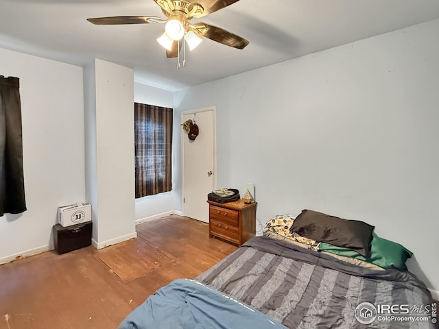 105 N Logan Ave, Haxtun, CO 80731 - bedroom featuring hardwood / wood-style flooring, baseboards, and a ceiling fan