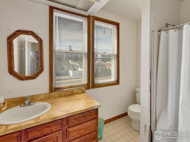 105 N Logan Ave, Haxtun, CO 80731 - bathroom with vanity, tile patterned floors, toilet, and a shower with curtain