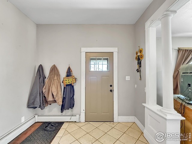 105 N Logan Ave, Haxtun, CO 80731 - foyer entrance with ornate columns, light tile patterned flooring, baseboards, a baseboard radiator, and a baseboard heating unit